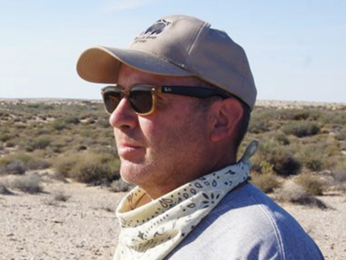 Side profile of archaeologist Jonathan Mabry in the field.
